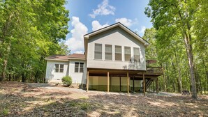 A two-story house with a covered porch and a garage. - Hot Springs Village Golf Getaway w/ Deck! (Hot Springs Village)