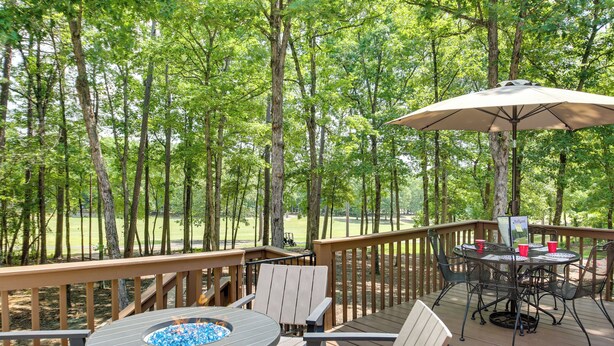 A wooden deck with a round table, chairs, and a fire pit. - Hot Springs Village Golf Getaway w/ Deck! (Hot Springs Village)