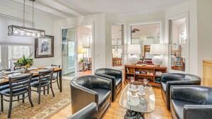 A spacious living room with a dining area, leather sofas, a glass coffee table, and a bookshelf. - Hot Springs Village Golf Getaway w/ Deck! (Hot Springs Village)