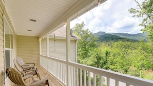 A porch with two Adirondack chairs and a view of a mountainous landscape. - Black Mountain Retreat w/ Hot Tub + Mountain Views (Black Mountain)