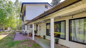 A house with a covered porch, large windows, and a garden area. - 3 Mi to Pioneer Park & University: Spacious Home! (Fairbanks)