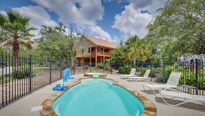 A swimming pool with lounge chairs and a house in the background. - Waterfront Pass Christian Oasis ~ 2 Mi to Beach! (Pass Christian)