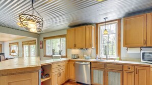 A kitchen with wooden cabinets, stainless steel appliances, and a wooden countertop. - Minnesota Cabin w/ Deck & Private Beach (Merrifield)