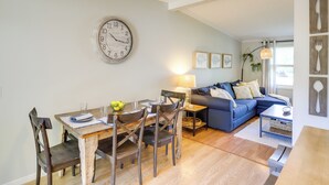 A dining area with a wooden table, chairs, and a clock on the wall. - Three Oaks Home w/ Guest House - 8 Mi to Beach! (Three Oaks)