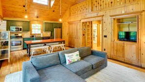 A wooden cabin interior with a dining area, kitchen, and living room. - Secluded Elka Park Cabin: Hot Tub & Fire Pit! (Tannersville)