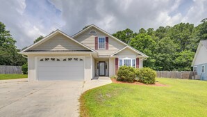 A single-story house with a garage, a front porch, and a well-maintained lawn. - Swansboro Vacation Rental, 4 Mi to Hammocks Beach! (Swansboro)