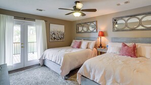 A bedroom with two beds, a ceiling fan, a large mirror, and a door leading to an outdoor area. - Lakefront Horseshoe Bend Home w/ Boat Dock! (Horseshoe Bend)