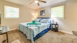 A bedroom with a bed, a desk, a chair, a ceiling fan, and a nightstand with a lamp. - Charming Jonesville Home w/ Grill - Near Wineries! (Jonesville)