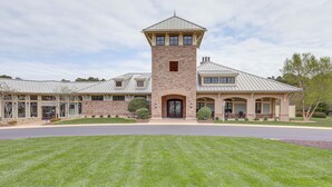 A large, two-story house with a prominent tower, a covered patio, and a well-maintained lawn. - Furnished Outdoor Space: Family Home in Ocean View (Ocean View)