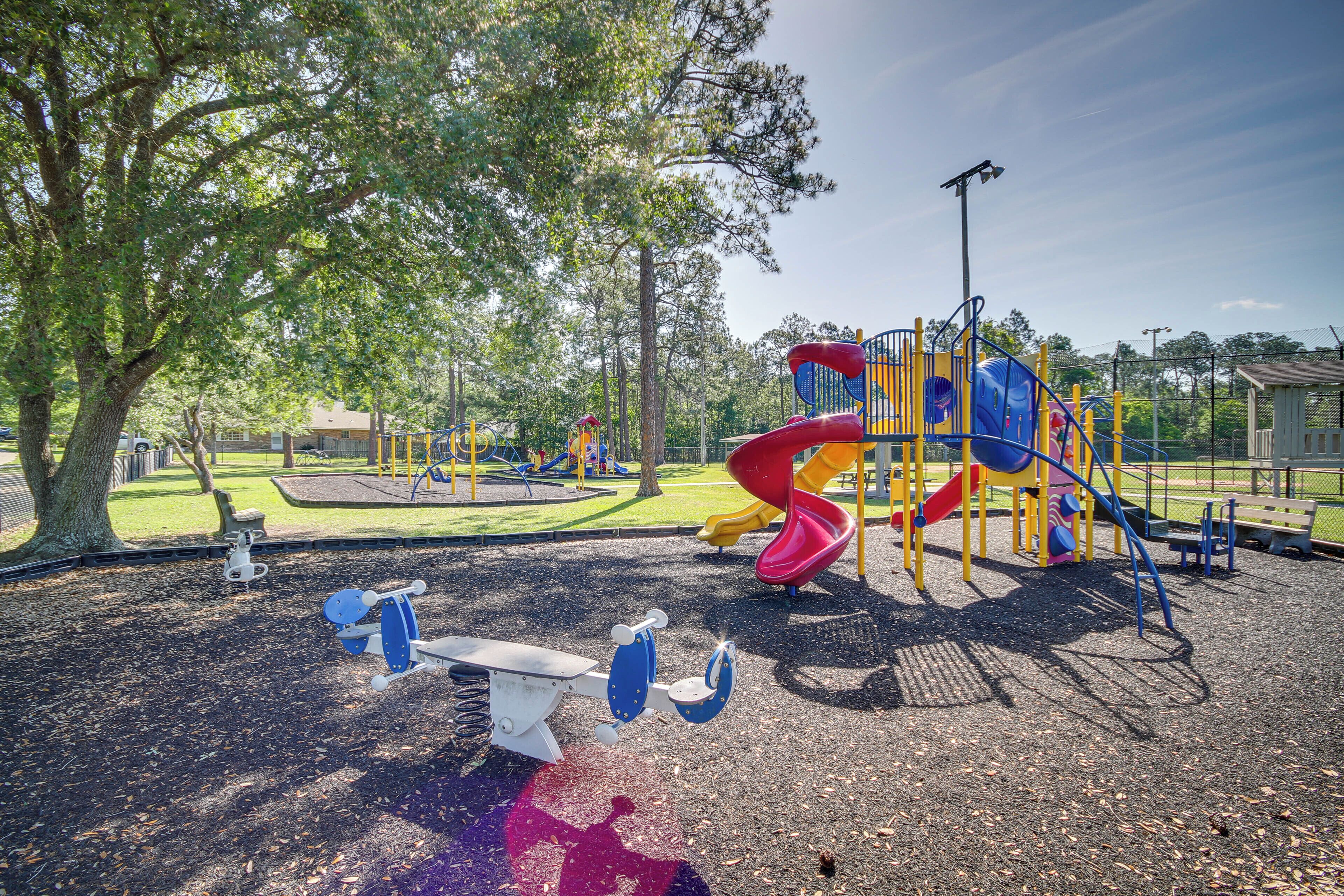 A playground with seesaws, a slide, and a climbing structure.