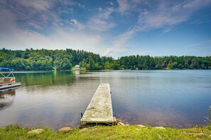 A calm lake with a dock extending into the water, surrounded by lush greenery and a clear sky. - Monterey Haven < 1/2 Mi to Lake Garfield w/ Kayaks (Monterey)