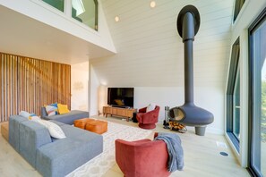 TV, fireplace, books - Stunning Vilas Cabin w/ Hot Tub + Mountain Views! (Vilas)