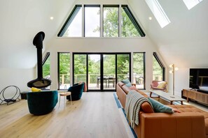 TV, fireplace, books - Modern A-frame North Carolina Cabin w/ Hot Tub (Vilas)