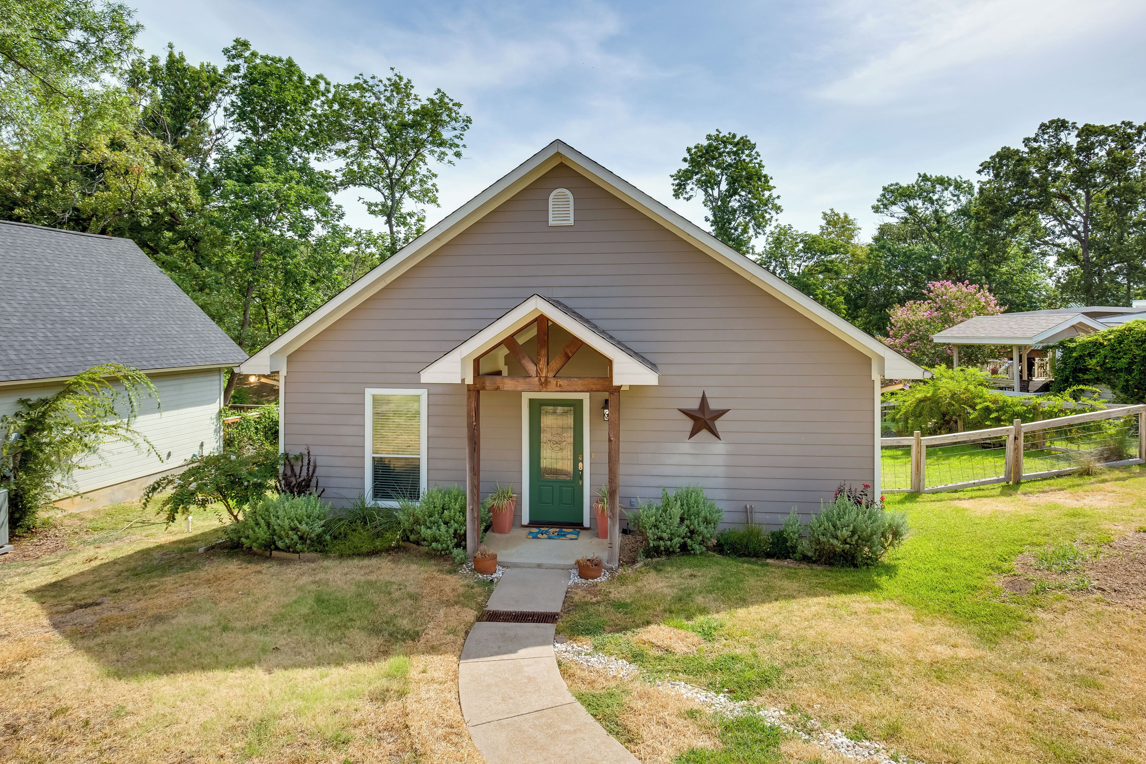 A single-story house with a gabled roof, a front porch, and a star decoration above the door.