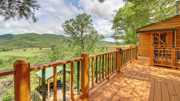 A wooden deck with a view of a green landscape and hills. - Secluded Mountain Cabin w/ Decks + Gazebo! (Warne)
