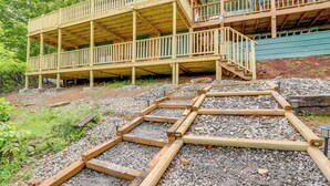A multi-level wooden deck with railings, surrounded by gravel and greenery. - Secluded Mountain Cabin w/ Decks + Gazebo! (Warne)
