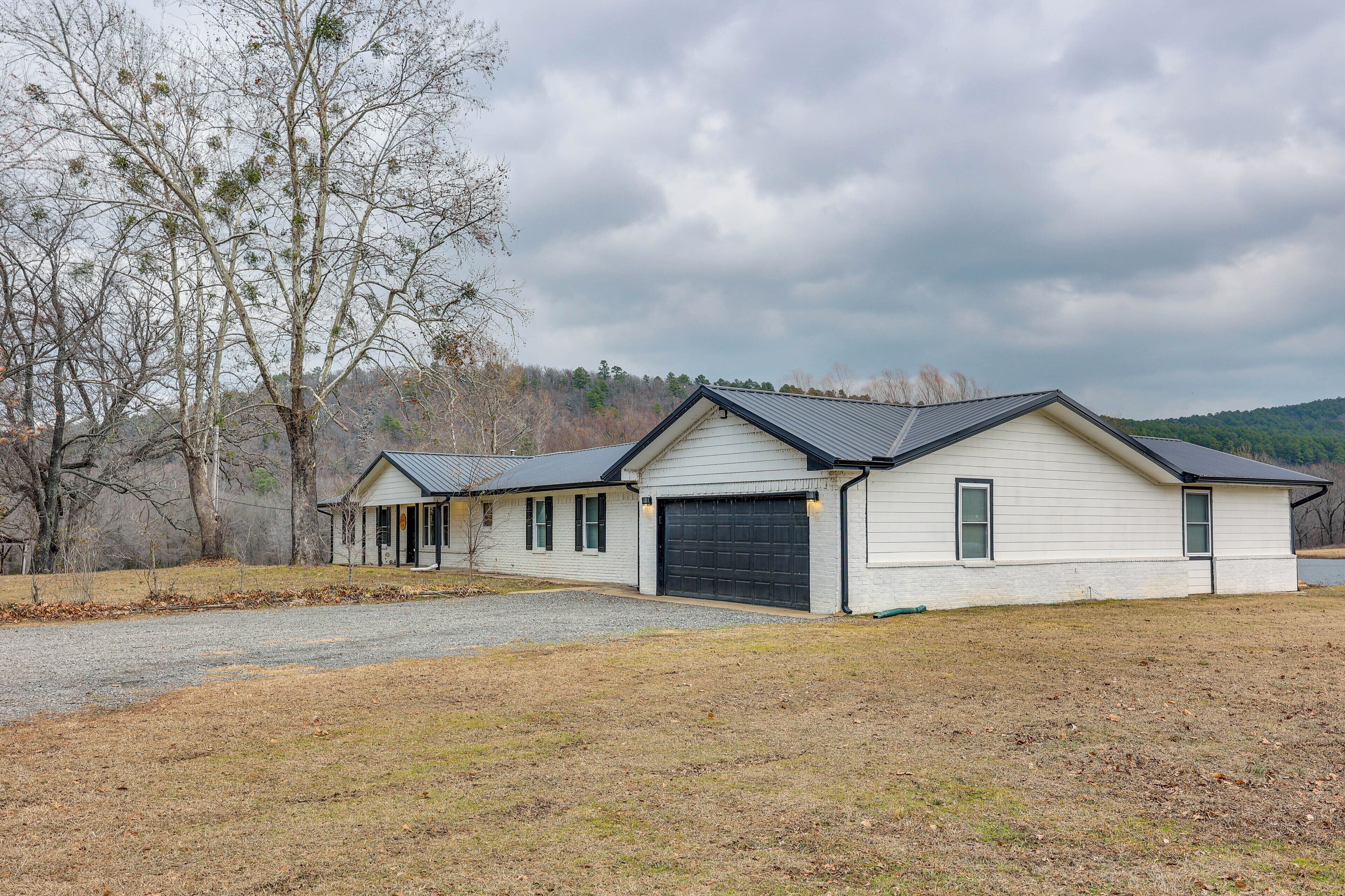 A two-story house with a garage, a driveway, and a grassy yard.