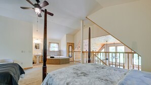 A spacious bedroom with a large bed, a ceiling fan, and a view of a balcony. - Marble Mountainside Escape w/ Wraparound Deck (Marble)