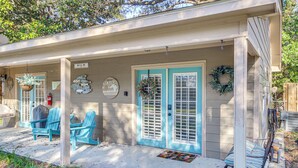 A house with a porch, two blue doors, and a sign that reads "Bay St Louis". - Walk to Beach: Waveland Retreat w/ Yard! (Waveland)