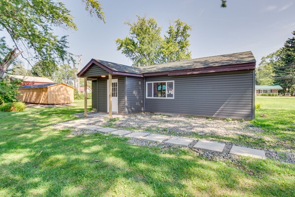 A single-story house with a front porch, a small attached garage, and a well-maintained lawn.