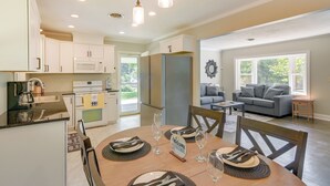 A modern kitchen with white cabinets, a built-in microwave, and a refrigerator. - Family-friendly Blacksburg Retreat w/ Playground! (Blacksburg)