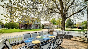 An outdoor patio with a table set for six, surrounded by chairs, and a white picket fence in the background. - Walk to Beach, Lake Edinboro Views: 'camp Dickson' (Edinboro)