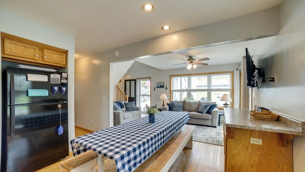 A modern kitchen with a built-in refrigerator, wooden cabinets, and a checkered tablecloth. - Walk to Beach, Lake Edinboro Views: 'camp Dickson' (Edinboro)