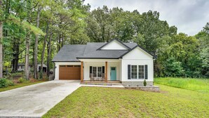 A single-story house with a front porch, a garage, and a well-maintained lawn. - Boat Ramp Access: Modern Kentucky Lake Home (Hardin)