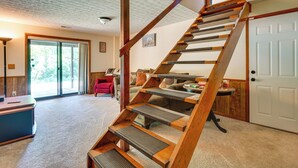 A staircase with wooden steps and a handrail, leading to a door. - Cabin w/ Deck ~ 3 Mi to Apple Valley Lake! (Howard)