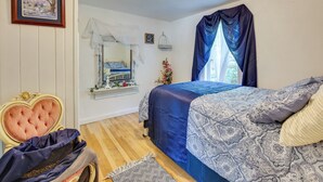 A bedroom with a bed, a vanity with a mirror, a dresser, and a chair. - Gillette Adventure Base 1 Mi to Historic Downtown! (Gillette)