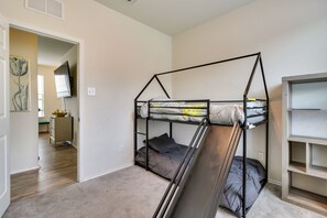 A bunk bed room with a desk and a TV. - Jarrell Home w/ Playground + Pool Access! (Jarrell)