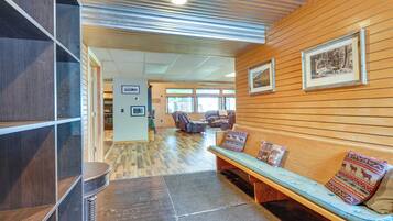 A lobby with a wooden bench, a reception desk, and framed artwork on the wall.