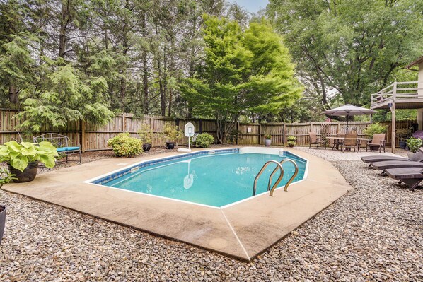 A rectangular swimming pool with a metal ladder, surrounded by a wooden fence and pebbles. - 3 Mi to Downtown: Inviting Lancaster Home! (Lancaster)