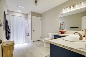 A modern bathroom with a shower, toilet, and sink. - 3 Mi to Downtown: Inviting Lancaster Home! (Lancaster)