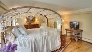 A bedroom with a canopy bed, a television, and a wooden dresser. - Mountain Biking Hub: 5 Mi to Berkshire East! (Charlemont)