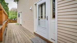 A wooden deck with a white door and a window with a decorative glass design. - Charming Elko Home w/ Pool Table! (Elko)