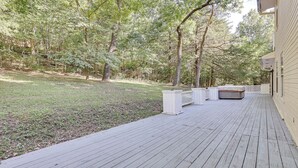 A wooden deck with a white fence, a covered seating area, and a house in the background. - Peaceful Pineville Vacation Rental w/ Grill! (Pineville)
