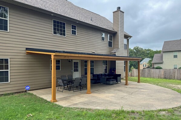 A two-story house with a covered patio area featuring outdoor furniture. - Fort Mitchell Vacation Rental w/ Home Office! (Fort Mitchell)