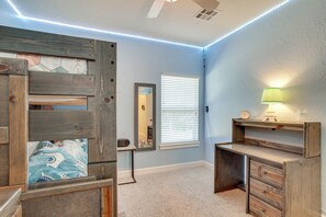 A bedroom with a bunk bed, a desk, a lamp, and a window with blinds. - Quaint Noble Home: 6 Mi to University of Oklahoma! (Noble)