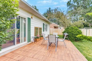 A wooden deck with outdoor furniture, a brick wall, and a wooden fence. - 1 Mi to Hersheypark: Home w/ Patio in Hershey! (Hershey)