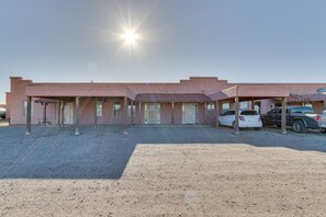Simple, covered outdoor seating areas surround this single-story building.