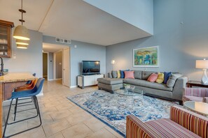 A modern living room with a sofa, striped chairs, a coffee table, and a TV. - Modern Point Venture Vacation Rental w/ Deck! (Leander)