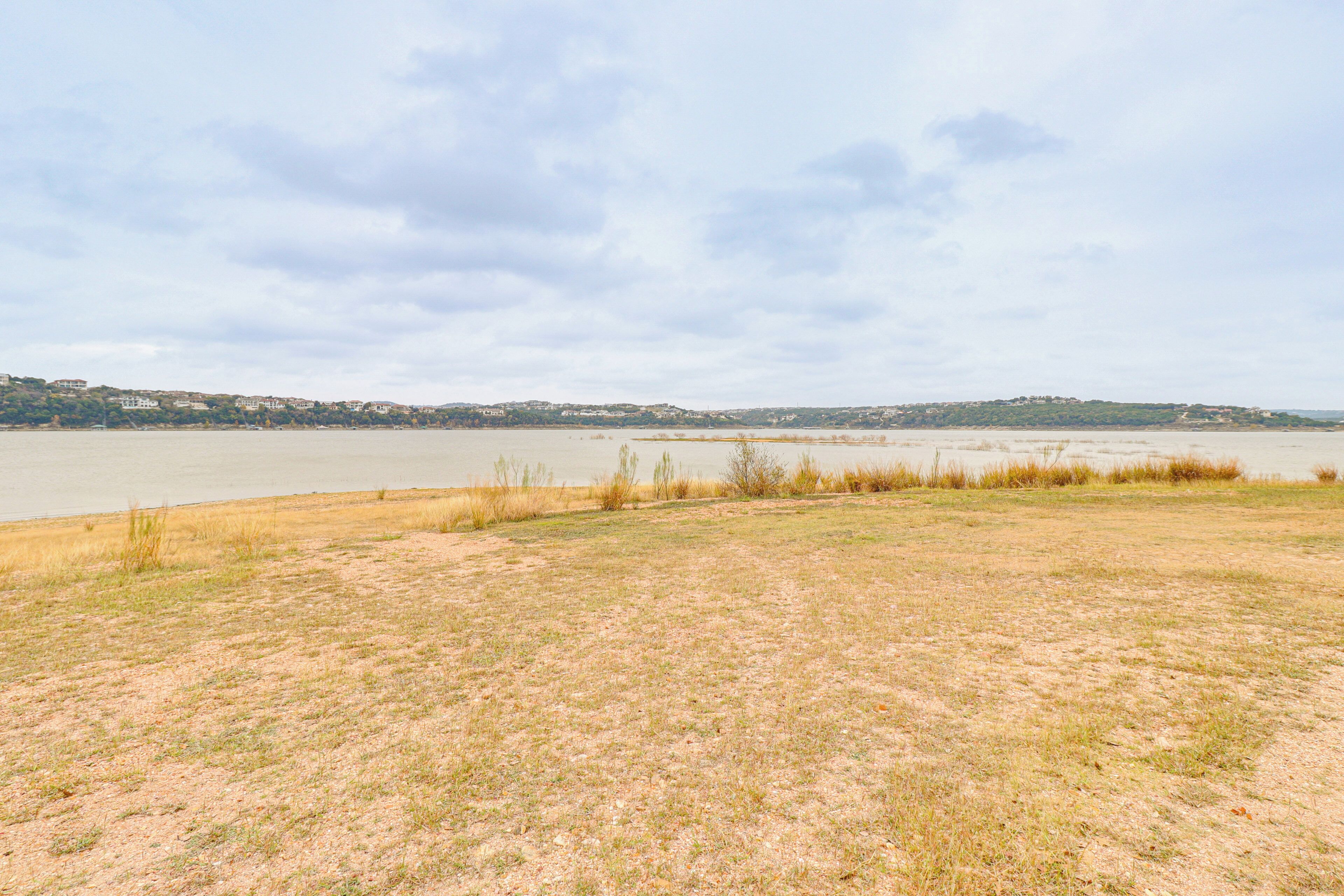 A wide, open field with a body of water in the background.