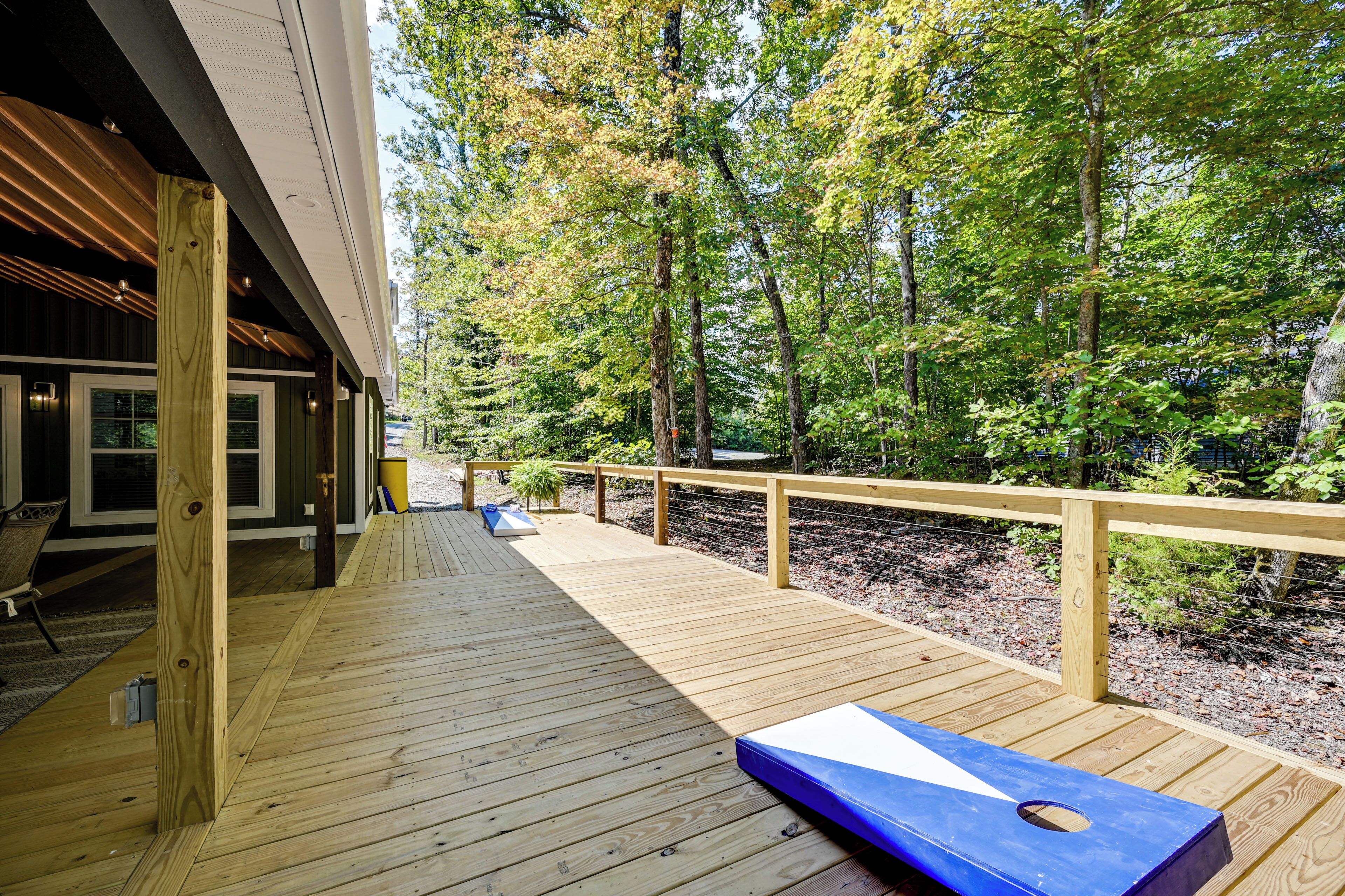 A wooden deck with a blue object, surrounded by trees.