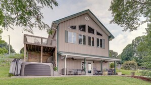 A two-story house with a covered porch, a garage, and a small deck. - Waterfront Bristol Area Retreat w/ Boat Dock (Blountville)