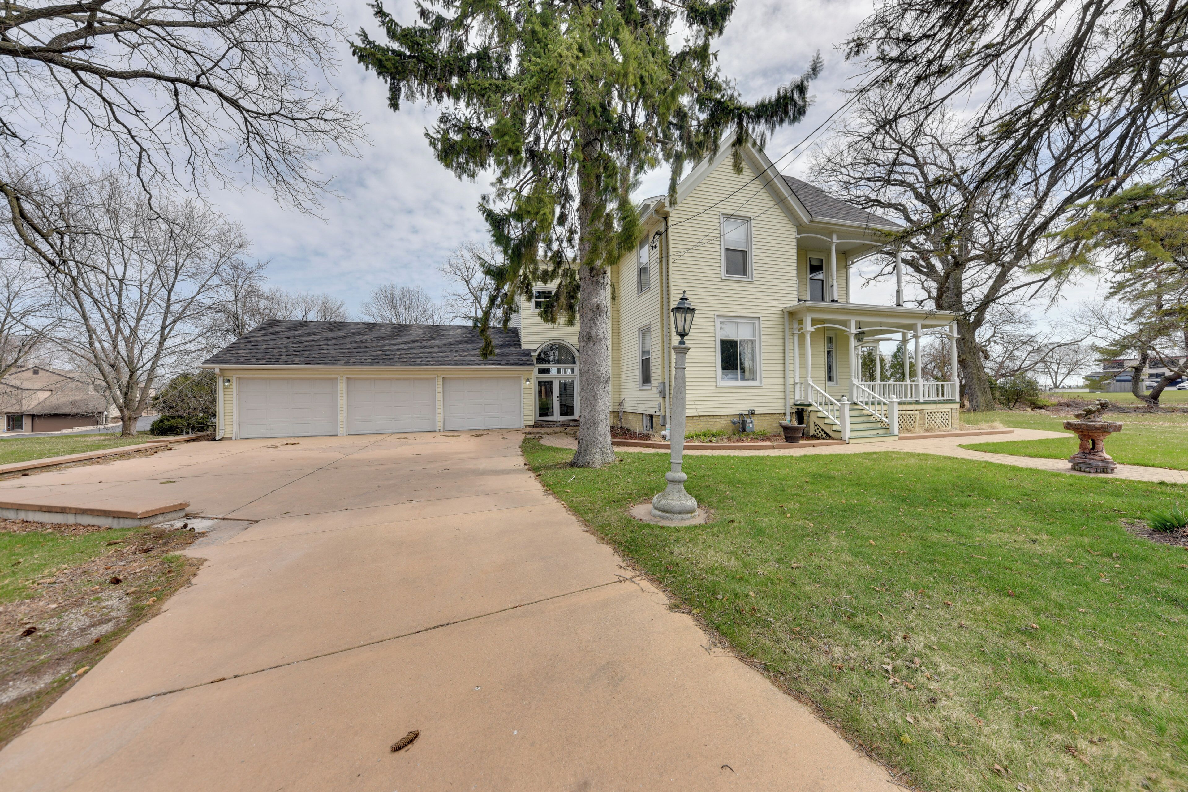 A two-story house with a covered front porch and a garage.