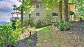 A two-story house with a covered porch and a satellite dish. - 40-acre Ararat Escape: On-site Trails & Mtn Views! (Hillsville)