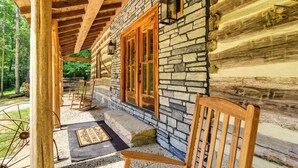 A log cabin with a stone exterior, wooden porch, and a welcome mat. - Glasgow Getaway w/ Patio, Fireplace & Grill! (Glasgow)