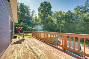 A wooden deck with a railing, a red chair, and a small shed in a wooded area. - Secluded Canton Vacation Rental 22 Mi to Asheville (Canton)