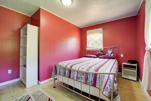 A bedroom with a bed, a nightstand, a wardrobe, and a window with curtains. - Secluded Canton Vacation Rental 22 Mi to Asheville (Canton)